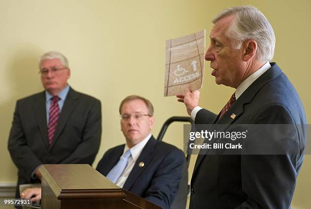 From right, House Majority Leader Steny Hoyer, D-Md., holds up the report on disability access to the Capitol as Rep. James Langevin, D-R.I., and...