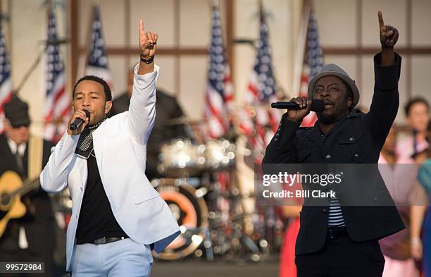 John Legend, left, accompanies will.i.am singing his song "Yes We Can" during the 2008 Democratic National Convention at Invesco Field in Denver,...
