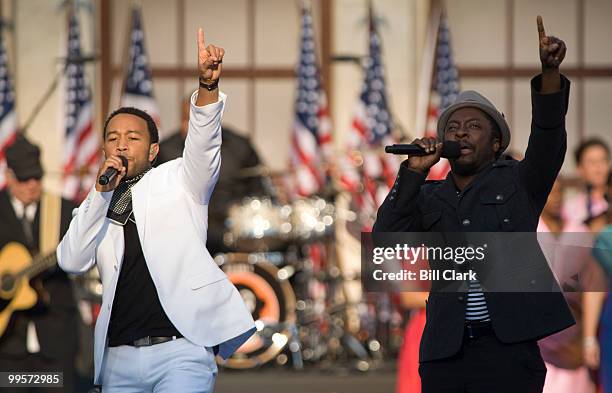 John Legend, left, accompanies will.i.am singing his song "Yes We Can"é-« during the 2008 Democratic National Convention at Invesco Field in Denver,...