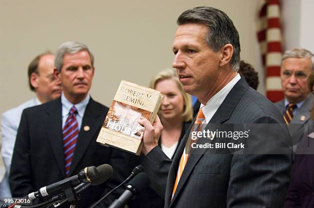 Freshman Rep. Tim Mahoney, D-Fla., holds up a copy of the "The House: The History of the House of Representatives" by Robert Remini during the news...