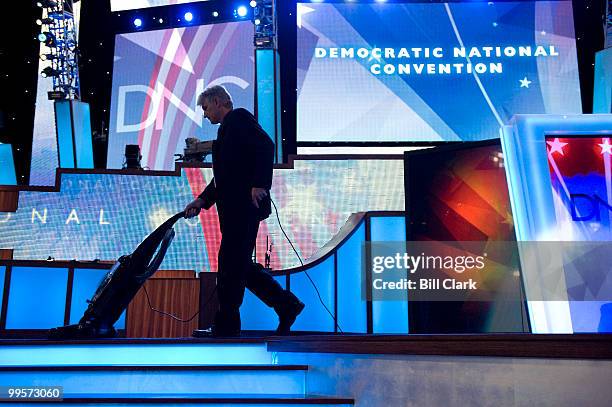 Stage hand vacuums the stage before the start of day 2 at the 2008 Democratic National Convention at the Pepsi Center in Denver, Colo., on Aug. 26,...