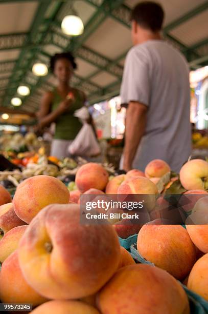 Peaches tempt the shoppers passing by the Sunnyside Farms' stand at Eastern Market in Washington on Saturday, July 28, 2007.