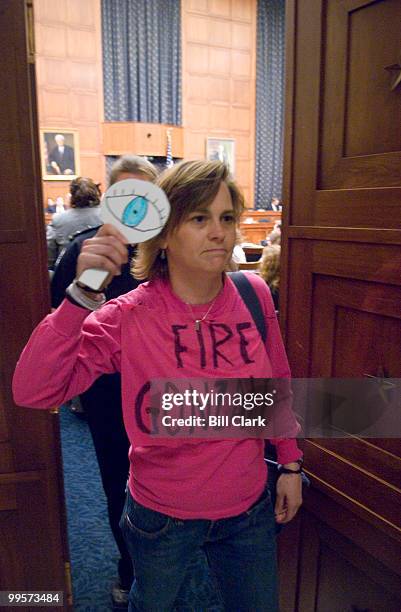 Code Pink's Lori Perdue is escorted out of the House Judiciary Committee hearing room by Capitol Police after refusing an order from committee staff...