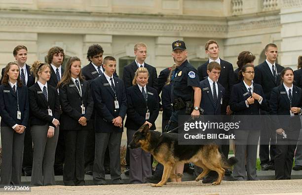 Capitol Police K-9 officer walks by Congressional pages as House and Senate members gathered on the East Front of the Capitol for the Congressional...