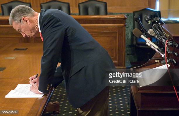 Sen. Charles Grassley, R-Iowa, makes notes on his prepared remarks as he waits for Commerce Secretary Carlos Gutierrez, Agriculture Secretary Mike...
