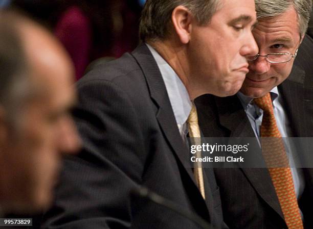 From left, Sen. Jeff Merkley, D-Ore., talks with Sen. Sheldon Whitehouse, D-R.I., during the Senate Health, Education, Labor and Pensions Committee...