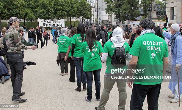 People act as if they were Israeli soldiers and Palestinian citizens during a demonstration to commemorate the "Nakba Day" , an annual day of...