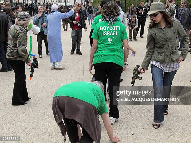 People act as if they were Israeli soldiers and Palestinian citizens during a demonstration to commemorate the "Nakba Day" , an annual day of...