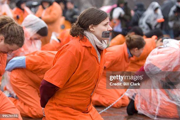 Amnesty International members and supporters gather on the National Mall dressed in orange jumpsuits to urge Congress and the Bush administration to...