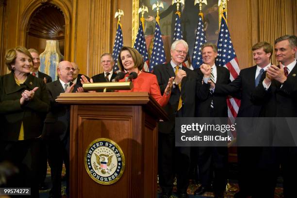 Speaker Nancy Pelosi, flanked by House Democratic leaders, holds a news conference following passage of the House healthcare reform legislation on...