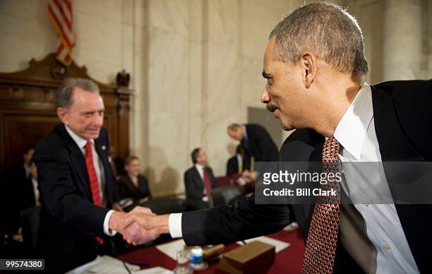 Eric Holder, nominee to be attorney general in the Obama administration, shakes hands with Sen. Arlen Specter, R-Pa., before the start of his...