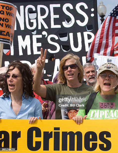 Iraq War activist Cindy Sheehan, center, founder of Gold Star Families for Peace, leads a march from Arlington National Cemetery over Memorial Bridge...