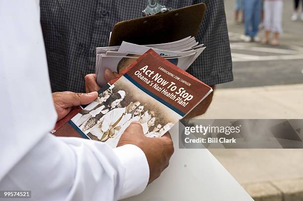 LaRouche supporter passes out literature comparing President Obama's health care proposals to Hitler and Nazi beliefs during the Recess Rally in...