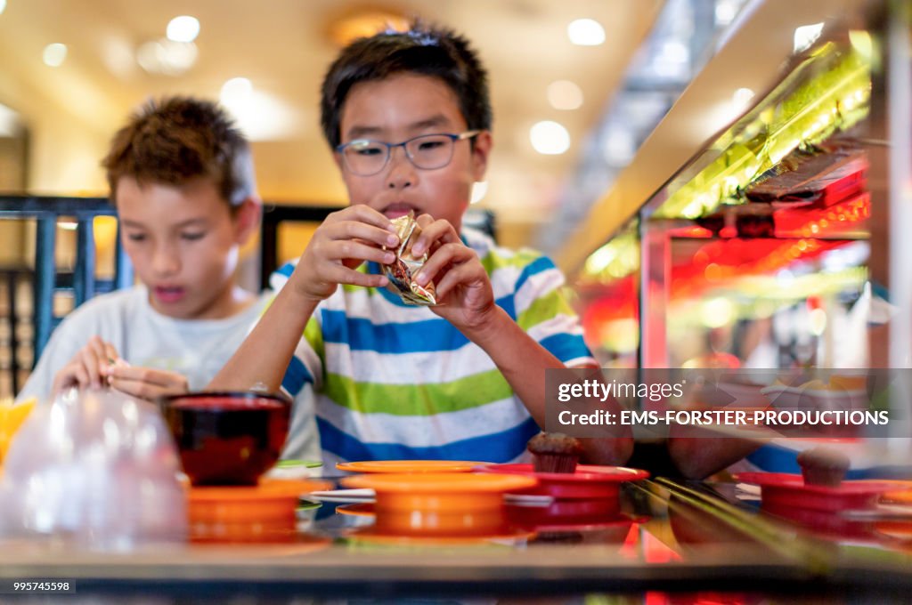 Two brothers of different fathers in asian restaurant