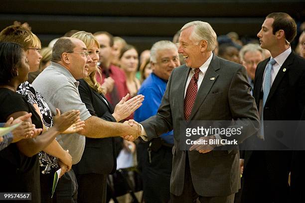 House Majority Leader Steny Hoyer, D-Md., followed closely by his security detail, shakes hands with audience members in the reserved seating section...