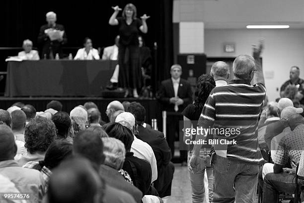 Some members of the audience walk out as they tire of long speeches from the stage during House Majority Leader Steny Hoyer's town hall meeting at...