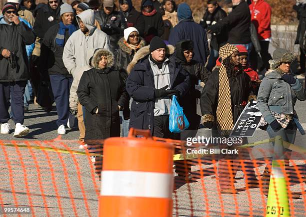 Spectators line up to go through security as they gather for President elect Barack Obama's train to pass by the Edgewood, Md., train station...