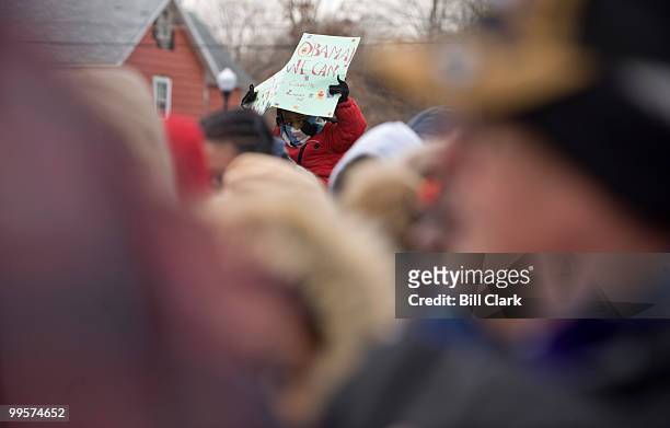 Young boy holds an Obama sign as hundreds wait for President elect Barack Obama's train to pass by the Edgewood, Md., train station as they from...