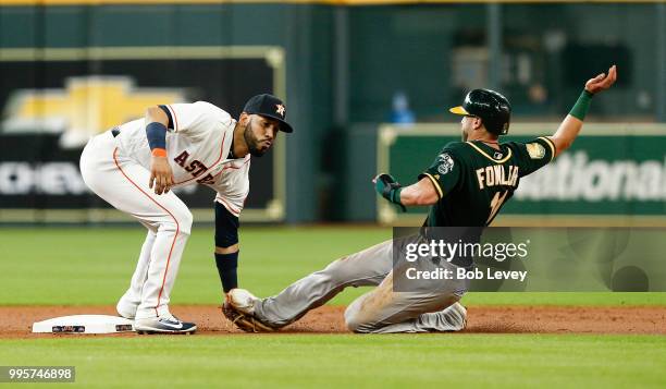 Dustin Fowler of the Oakland Athletics is tagged out by Marwin Gonzalez of the Houston Astros in the first inning at Minute Maid Park on July 10,...