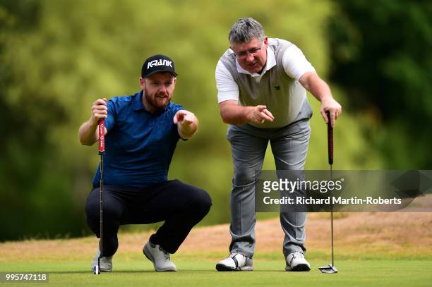 Amateur Stephen Daynes lines up a putt with Paul Woodcock of Manchester Golf Club during the Lombard Trophy North of England Qualifier at Sandiway...