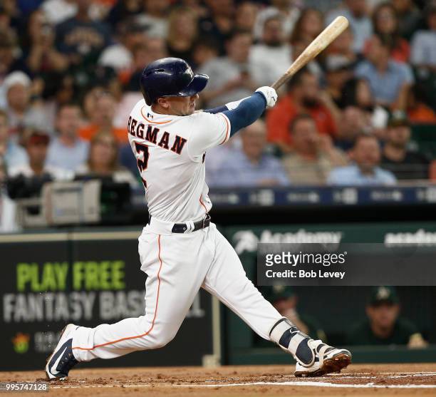 Alex Bregman of the Houston Astros hits a home run in the first inning against the Oakland Athletics at Minute Maid Park on July 10, 2018 in Houston,...