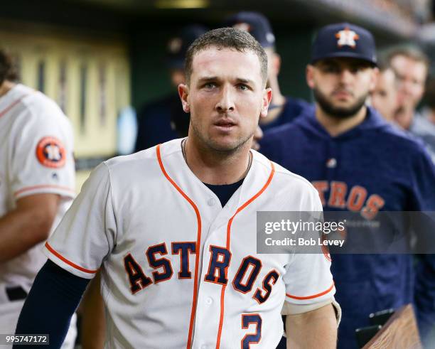 Alex Bregman of the Houston Astros celebrates in the dugout after hitting a home run in the first inning against the Oakland Athletics at Minute Maid...