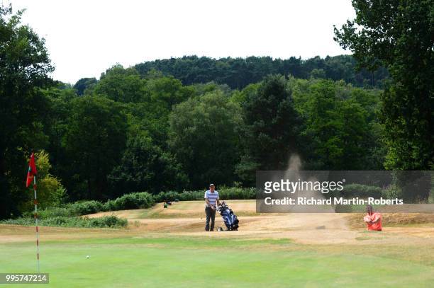 Amateur Andy Nolan of Dukinfield Golf Club hits from a bunker during the Lombard Trophy North of England Qualifier at Sandiway Golf Club on July 10,...