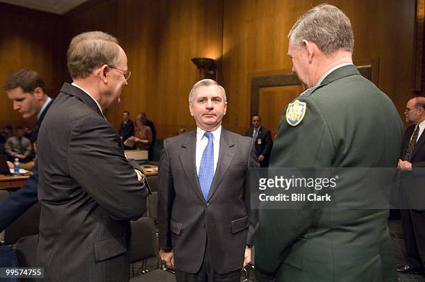 Sen. Jack Reed, D-R.I., center, stands at attention as he jokes around with former West Point classmate Defense Intelligence Agency Director Lt. Gen....