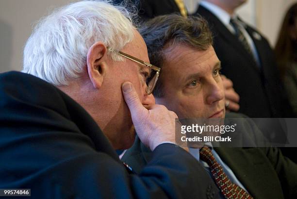 Sen. Bernie Sanders, I-Vt., whispers to Sen. Sherrod Brown, D-Ohio during a news conference with Veterans of the war in Iraq, to discuss the effects...