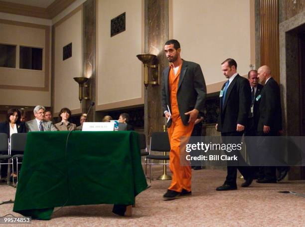 Evangelos Soukas, who is currently serving prison time for tax fraud, arrives under tight security to testify during the Senate Finance Committee...