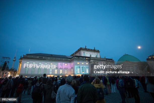 The Staatsoper is illuminated as part of the Festival of Lights in Berlin, Germany, 30 September 2017. Photo: Jörg Carstensen/dpa