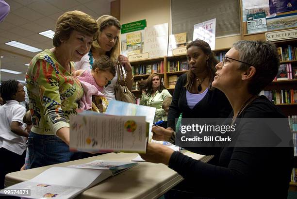 Actress Jamie Lee Curtis signs copies of her children's book "Is There Really a Human Race?" after reading from the book at Olsson's Books and...