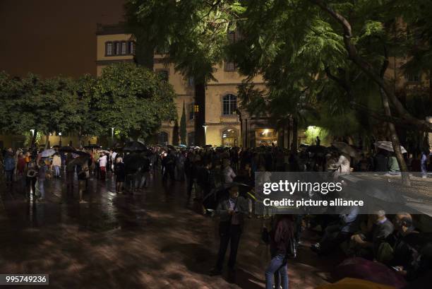 People who have gathered outside Escola de Treball school in Barcelona, Spain, in the early houes of 1 October 2017. Hundreds of people have...