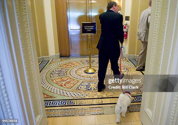 Sen. Kent Conrad, D-N. Dak., and his dog Dakota walk from the second floor elevators to the Senate Democrats Policy Lunch on Tuesday, June 23, 2009.