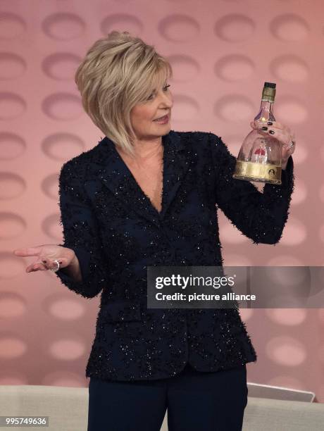 Presenter Carmen Nebel with a bottle on stage during the ZDF TV show "Willkommen bei Carmen Nebel" at the TUI-Arena in Hanover, Germany, 30 September...