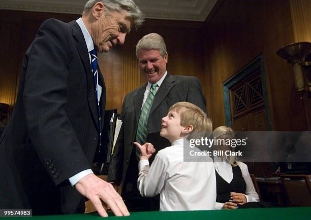 From left, Sen. John Warner, R-Va., greets Stanley Thomas Anderson, nominee to be U.S. District Judge for the Western District of Tennessee, his son...