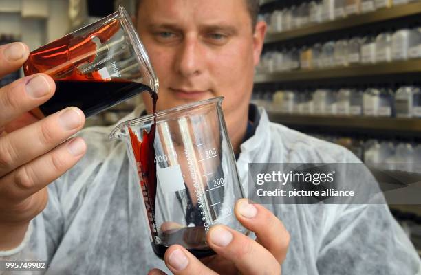 Lab manager Jochen Gottfriedsen fills "Supreme Blood External" fake blood into a measuring beaker at the Kryolan company lab in Berlin, Germany, 21...