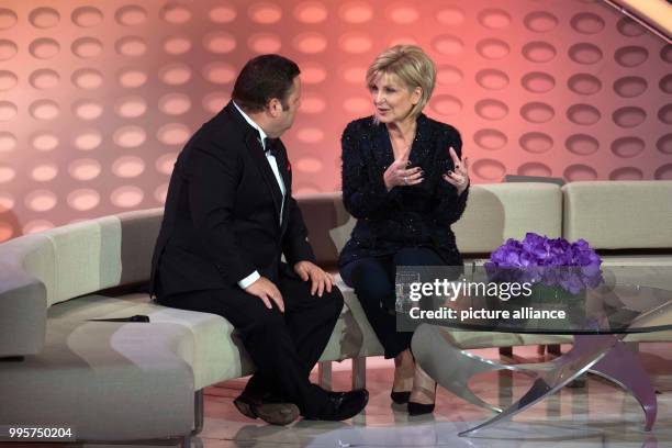 British tenor Paul Potts and presenter Carmen Nebel on stage during the ZDF TV show "Willkommen bei Carmen Nebel" at the TUI-Arena in Hanover,...