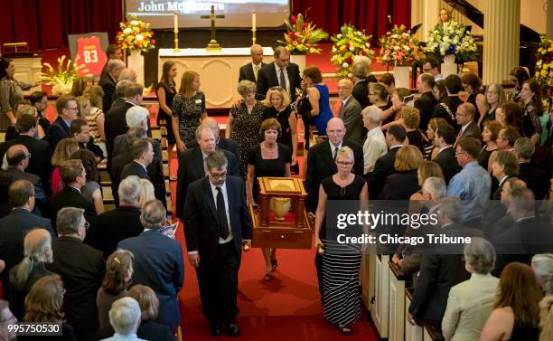 Andrea Chamblee, with sunglasses, the widow of Capital Gazette editor John McNamara, is accompanied by Cindy Chamblee as she follows his ashes in a...