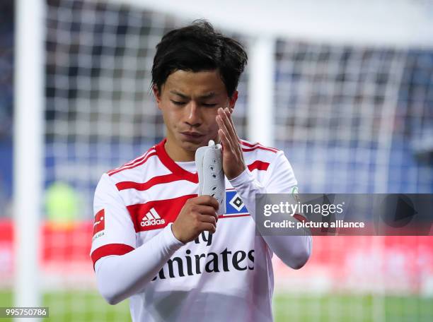 Hamburg's Ttsuya Ito goes off injured during the German Bundesliga football match between Hamburg SV and Werder Bremen at the Volksparkstadion in...