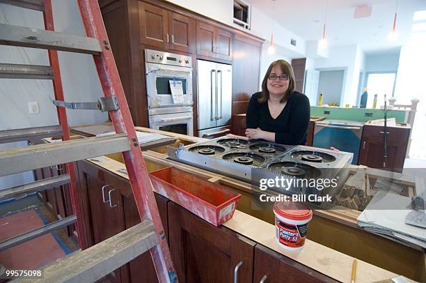 Leah Daniels, owner of Hill's Kitchen, poses in the cooking class kitchen on the second floor of the store, which is still under construction, on...