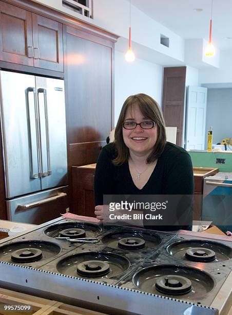 Leah Daniels, owner of Hill's Kitchen, poses in the cooking class kitchen on the second floor of the store, which is still under construction, on...