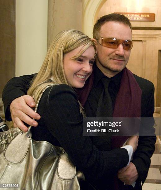 Former Lantos intern Lauren Prince poses for a photo with U2's Bono after the memorial service for Rep. Tom Lantos, D-Calif., outside of Speaker...