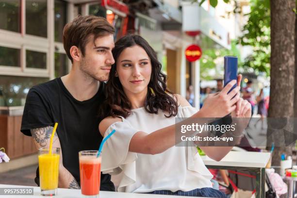 couple taking a selfie - cheek tongue stock pictures, royalty-free photos & images