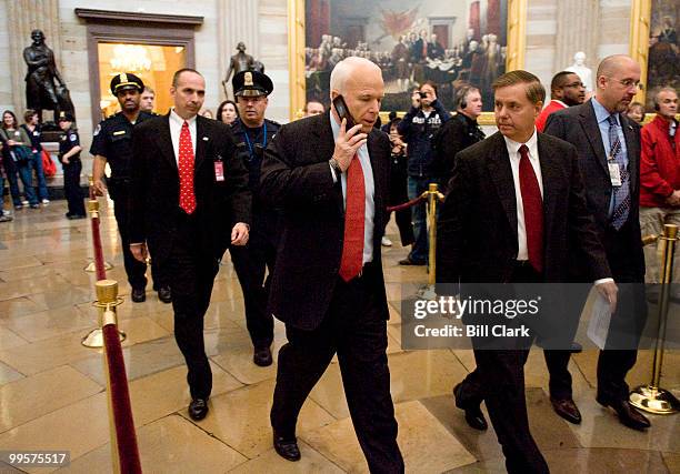 Republican presidential candidate John McCain and Sen. Lindsey Graham, R-S.C., walk through the Rotunda after meeting with House Minority Leader John...