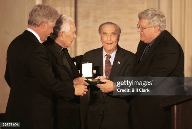 Pres. Bill Clinton, Rev. Theodore Hesburgh, Sen Strom Thurmond, and Speaker dennis Hastert pose with the Congressional Gold Medal.