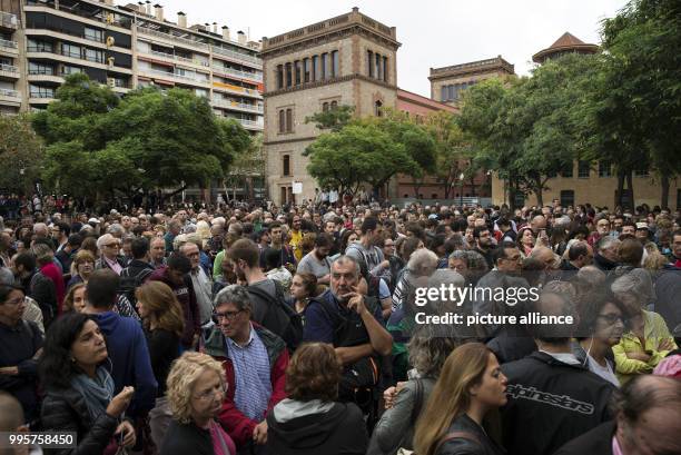 People wait outside Escola de Treball school to cast their ballots during the Catalan independence referendum in Barcelona, Spain, 1 October 2017....
