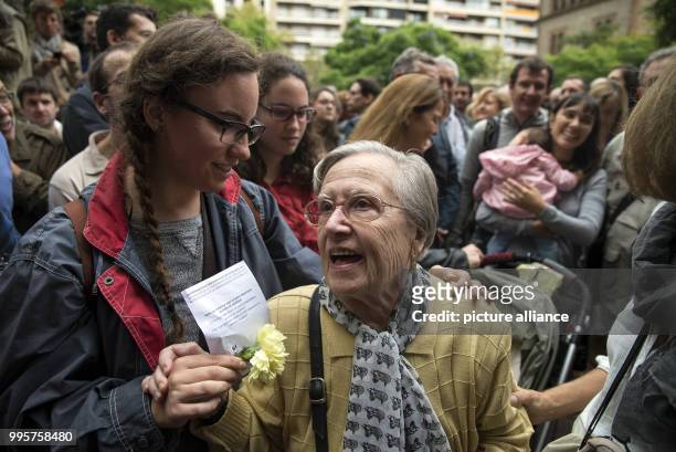 An elderly Catalan woman waits to cast her ballot during the Catalan independence referendum outside the Escola de Treball school, in Barcelona,...