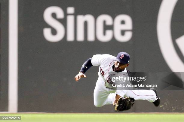 Jackie Bradley Jr. #19 of the Boston Red Sox makes a diving catch in the sixth inning of a game against the Texas Rangers at Fenway Park on July 10,...