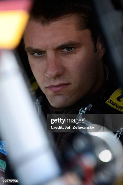 David Ragan, driver of the UPS Ford, sit in his car during practice for the NASCAR Sprint Cup Series Autism Speaks 400 at Dover International...